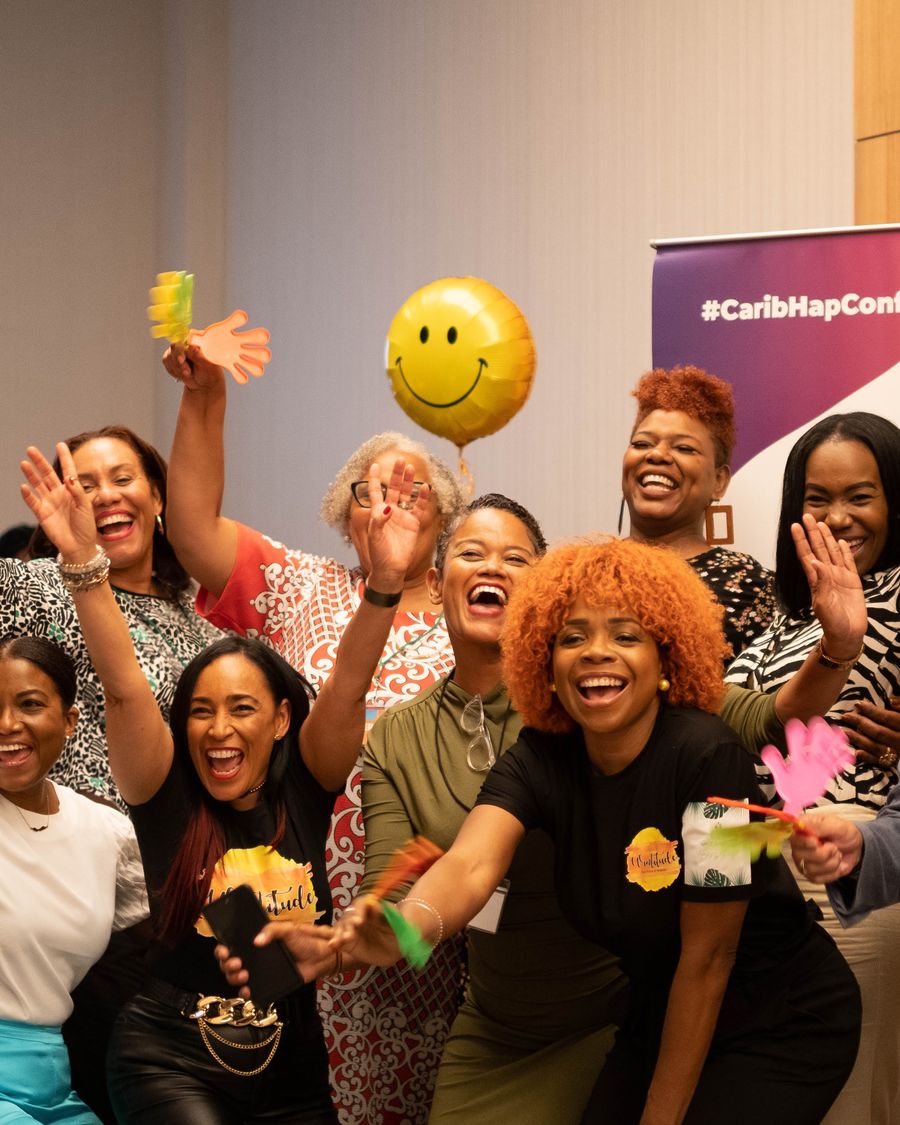 Attendees celebrating together at a past Caribbean Happiness Conference