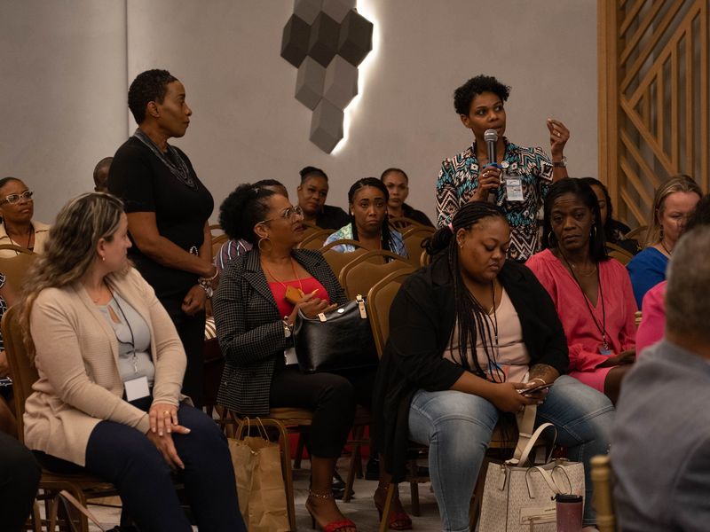 Attendees laughing during a session