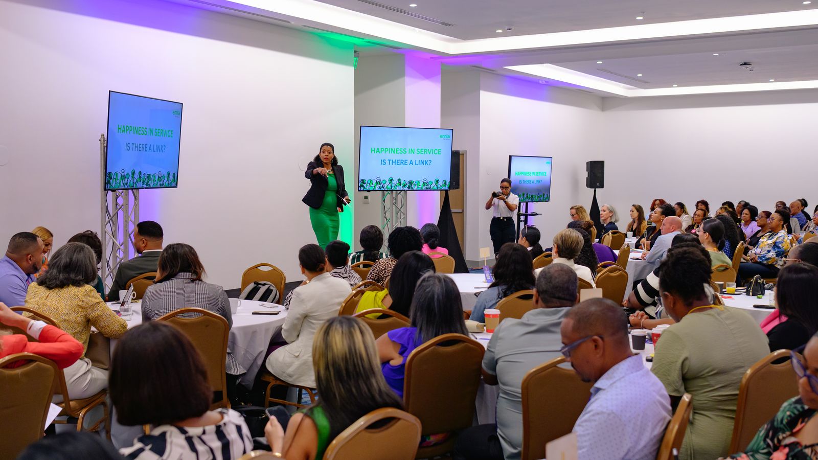A packed, vibrant session at a past Caribbean Happiness Conference